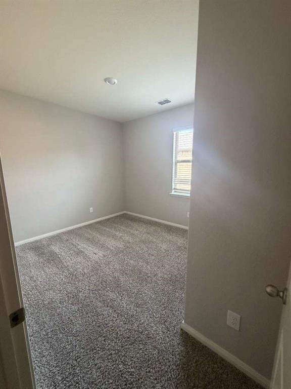 310 Foster Lane Anna, TX 75409 - Photo 14 of 15 Spacious room featuring neutral carpeting, light-colored walls, and a window with horizontal blinds