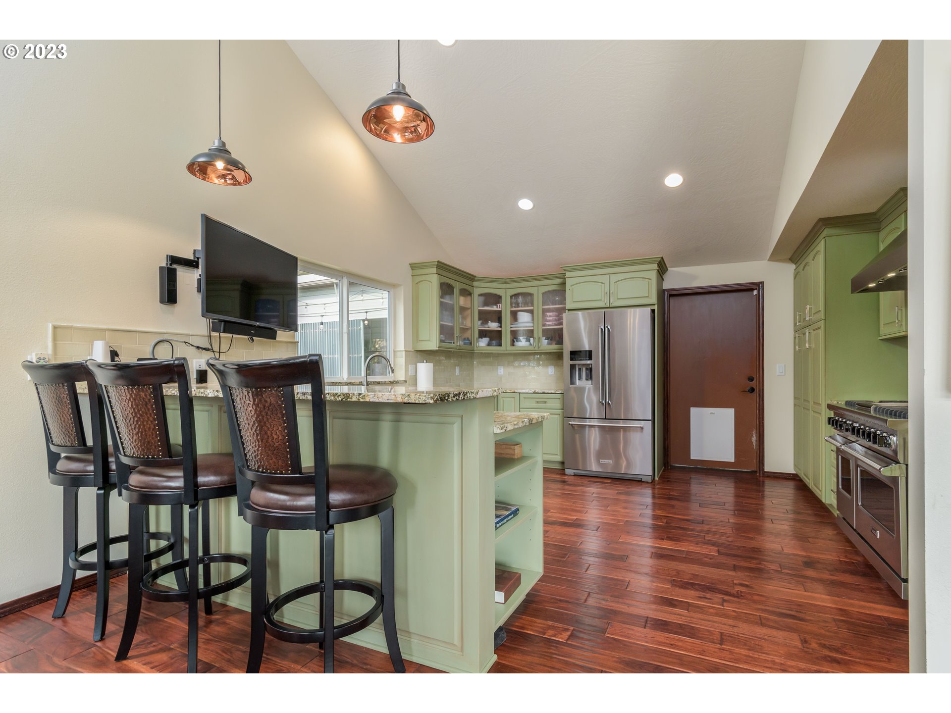 39350 Eagles Rest Road Dexter, OR 97431 - Photo 13 of 42 a kitchen with stainless steel appliances granite countertop a table chairs microwave and sink