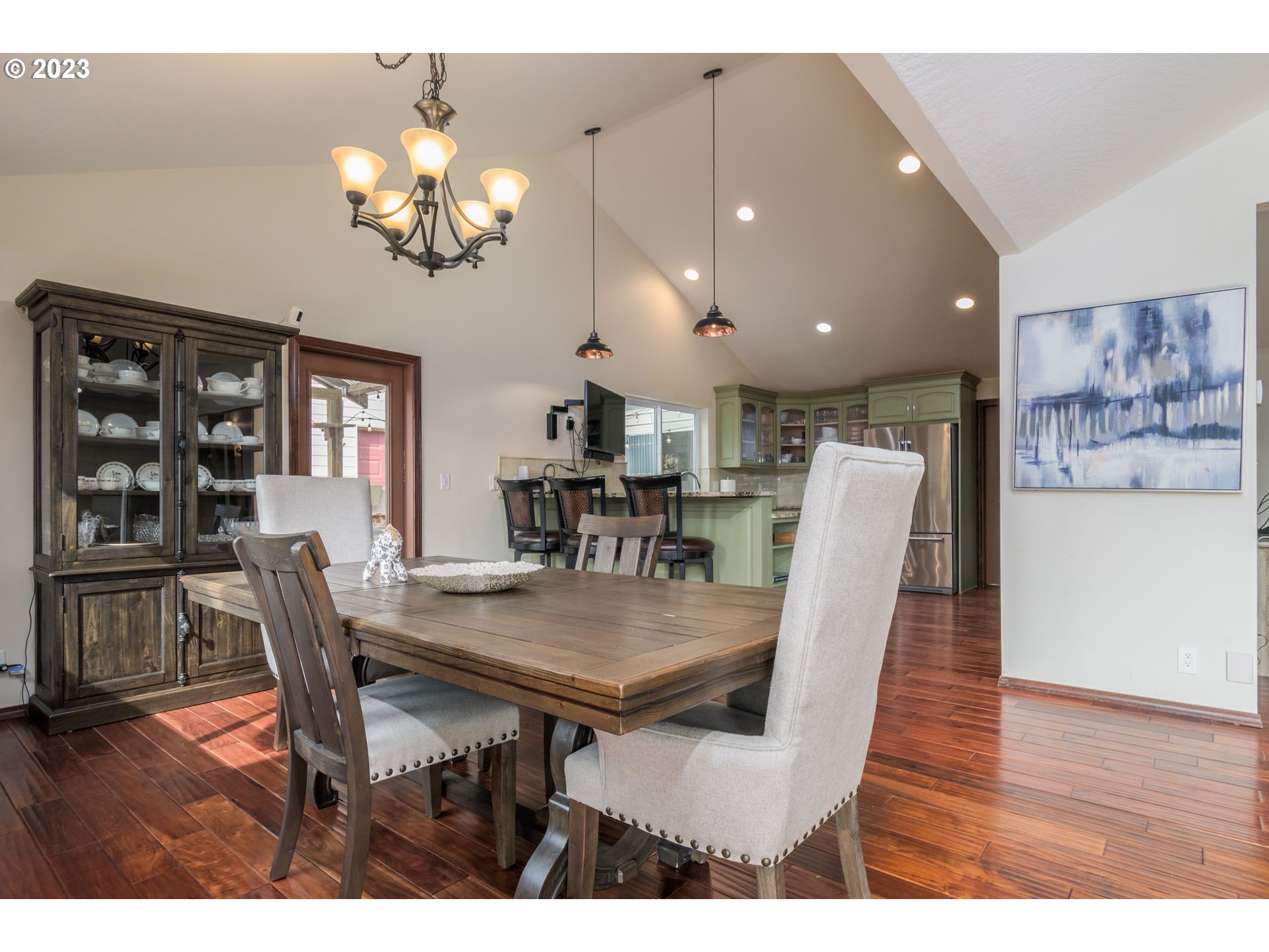 39350 Eagles Rest Road Dexter, OR 97431 - Photo 8 of 42 a dining room with wooden floor a chandelier a wooden table and chairs