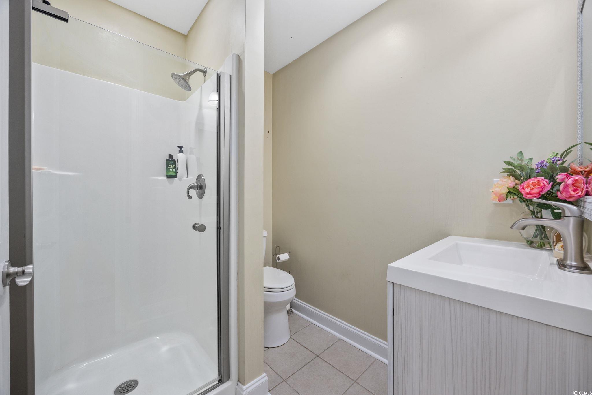 11569 Bay Drive Little River, SC 29566 - Photo 13 of 40 Full bath with a stall shower, vanity, and tile patterned flooring