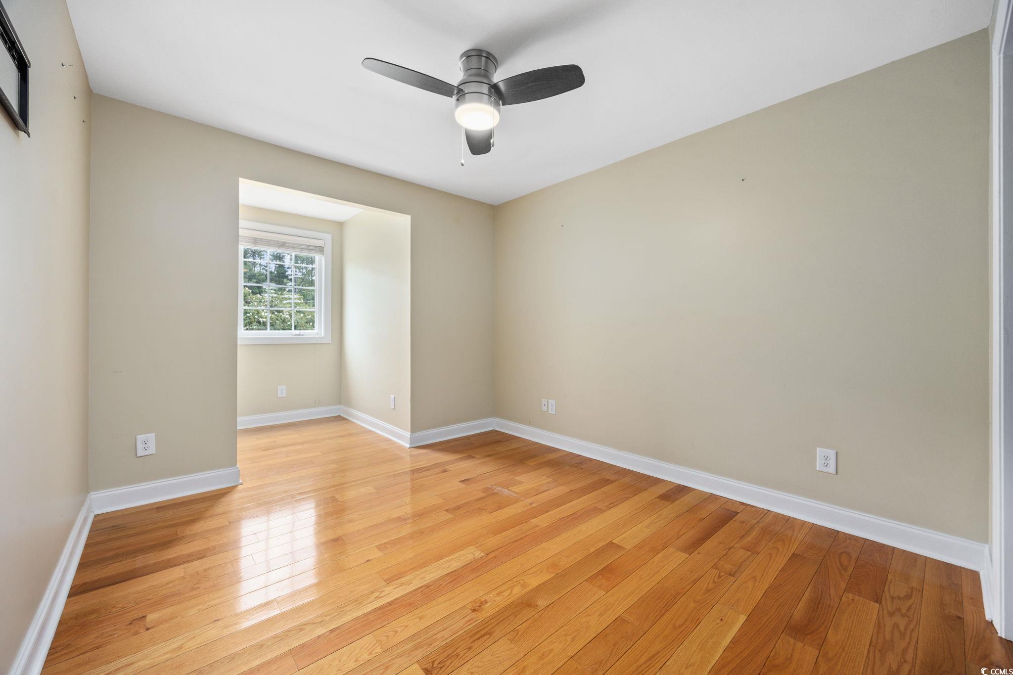 11569 Bay Drive Little River, SC 29566 - Photo 20 of 40 Spare room with light wood-type flooring and a ceiling fan