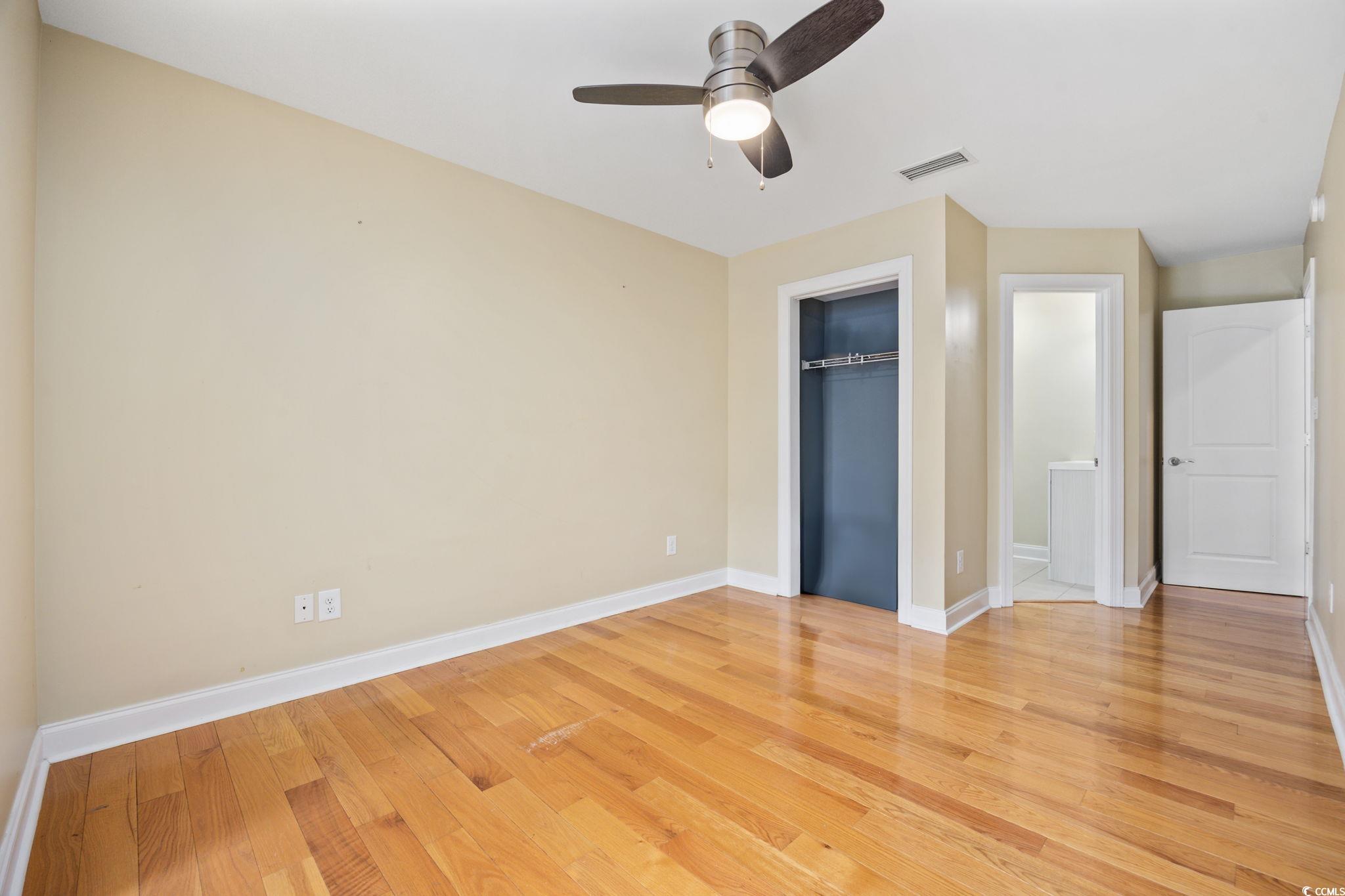 11569 Bay Drive Little River, SC 29566 - Photo 21 of 40 Unfurnished bedroom with light wood finished floors and ceiling fan