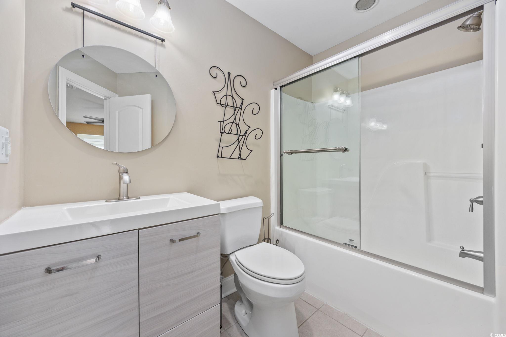 11569 Bay Drive Little River, SC 29566 - Photo 24 of 40 Bathroom featuring vanity, shower / bath combination with glass door, and tile patterned flooring