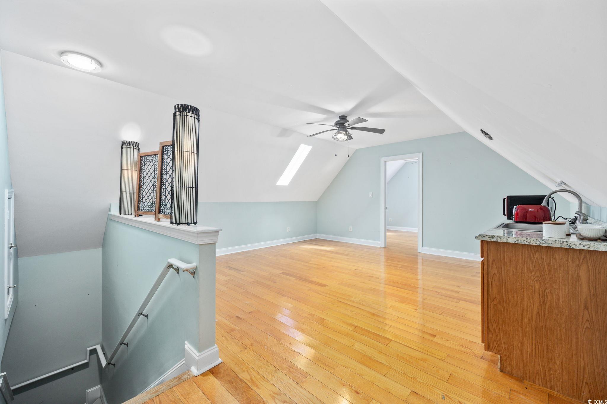 11569 Bay Drive Little River, SC 29566 - Photo 29 of 40 Additional living space featuring vaulted ceiling, a skylight, light wood-style flooring, and a ceiling fan