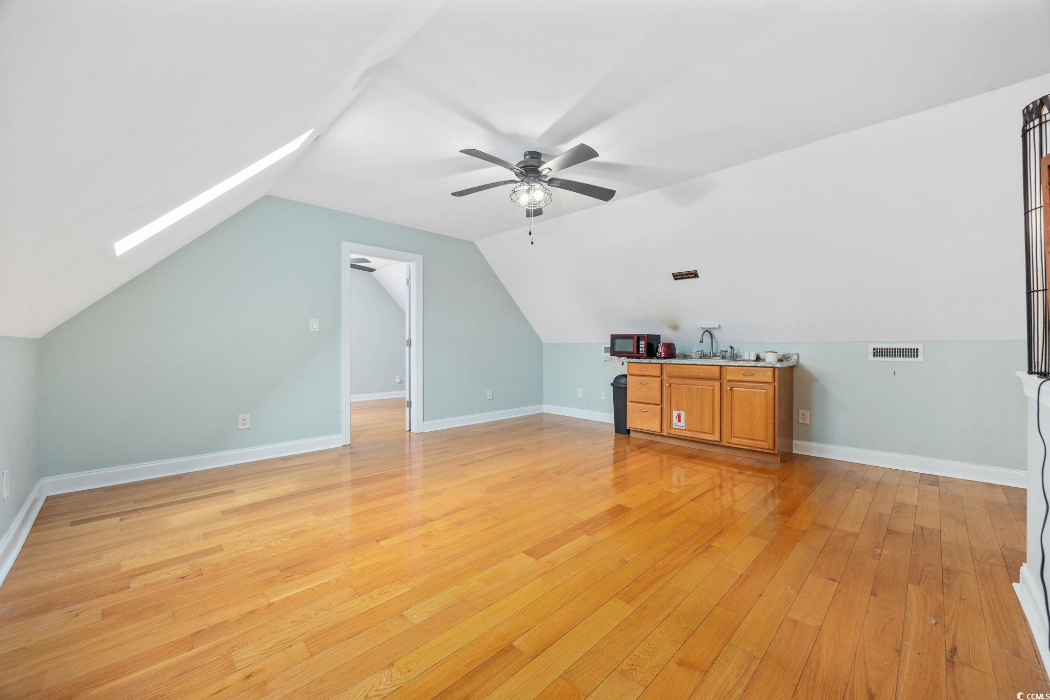 11569 Bay Drive Little River, SC 29566 - Photo 30 of 40 Additional living space with light wood finished floors, vaulted ceiling, and ceiling fan