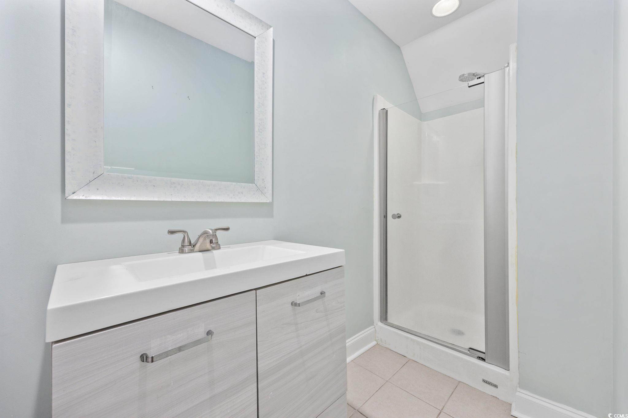 11569 Bay Drive Little River, SC 29566 - Photo 31 of 40 Full bath featuring a stall shower, vanity, and tile patterned flooring