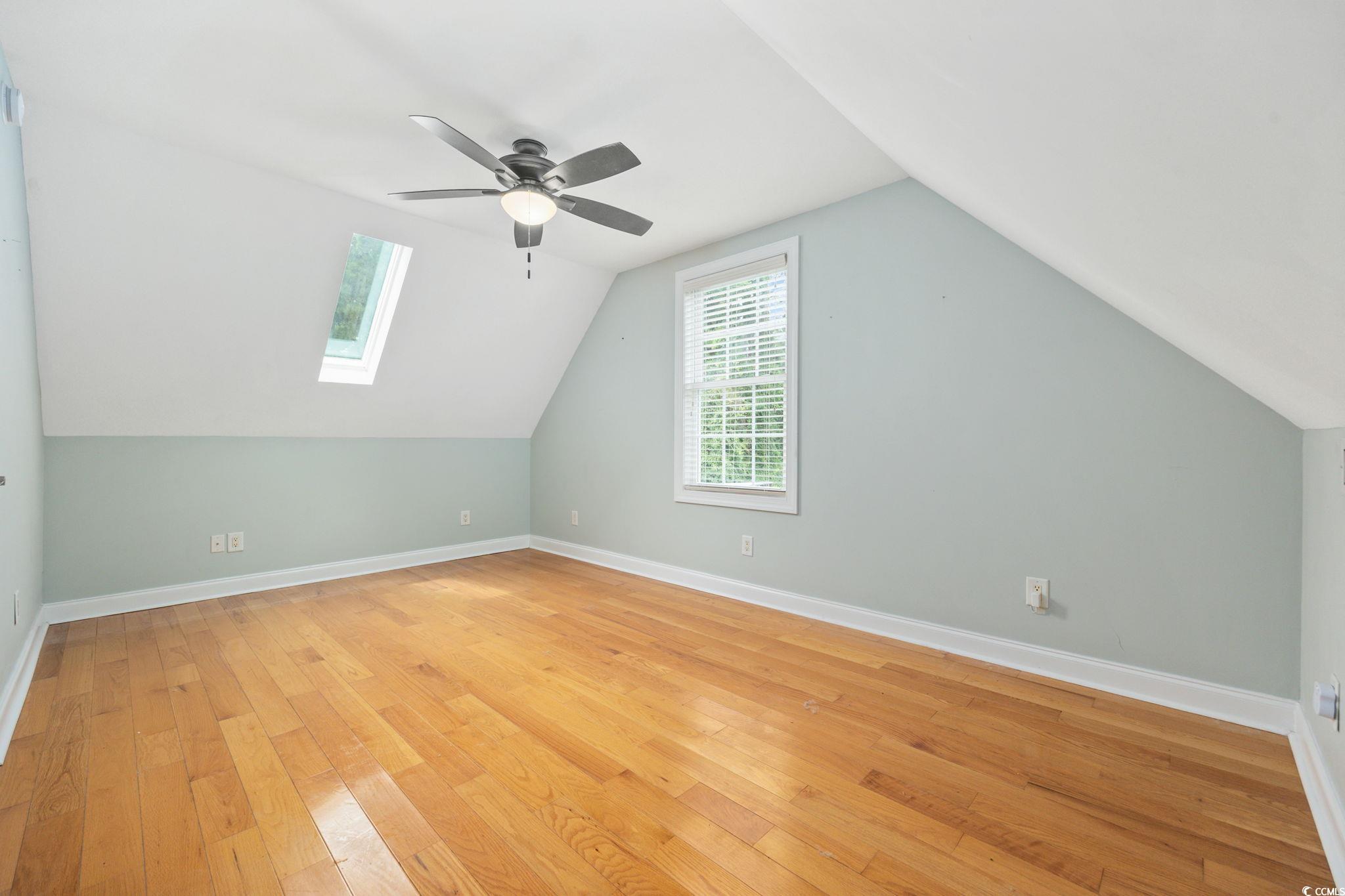 11569 Bay Drive Little River, SC 29566 - Photo 32 of 40 Bonus room featuring vaulted ceiling, light wood finished floors, ceiling fan, and a skylight