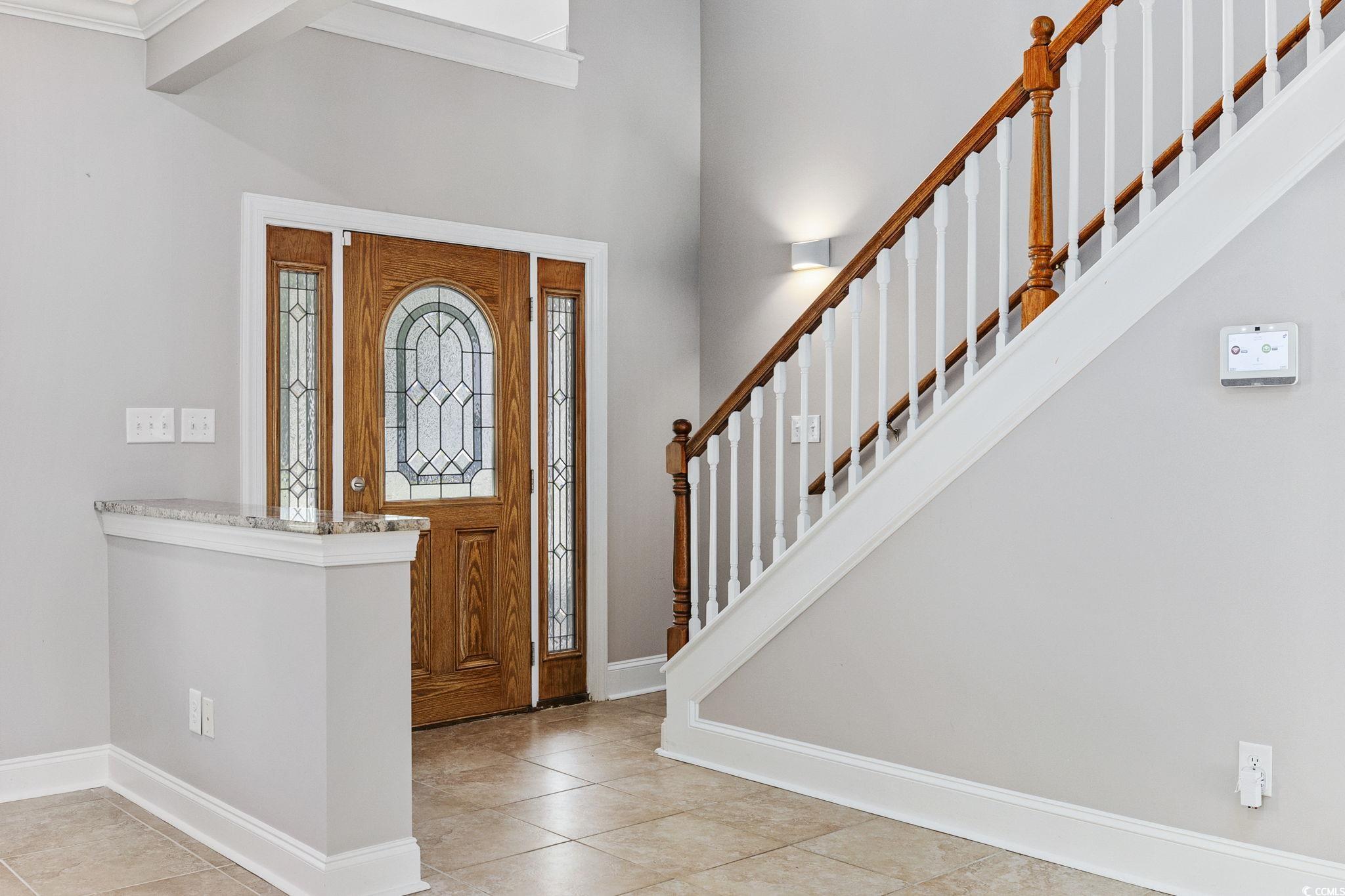 11569 Bay Drive Little River, SC 29566 - Photo 5 of 40 Foyer featuring tile patterned flooring and stairs