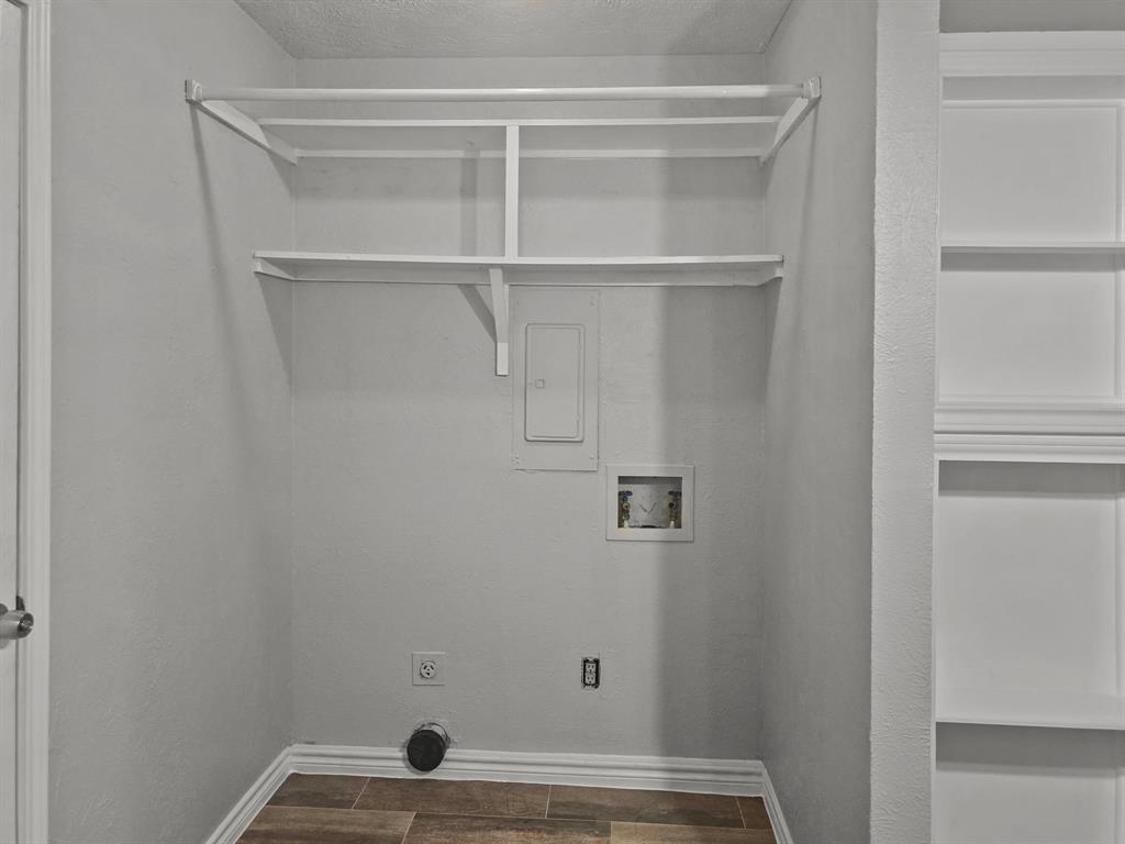 701 Idlewilde Drive Lewisville, TX 75067 - Photo 12 of 13 Laundry room in kitchen with hookup for a washing machine, hookup for an electric dryer, and dark wood-style flooring