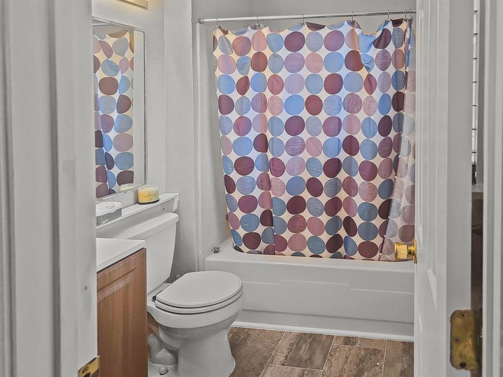 701 Idlewilde Drive Lewisville, TX 75067 - Photo 5 of 13 Bathroom featuring shower / tub combo and vanity, flooring updated approximately 1 year ago