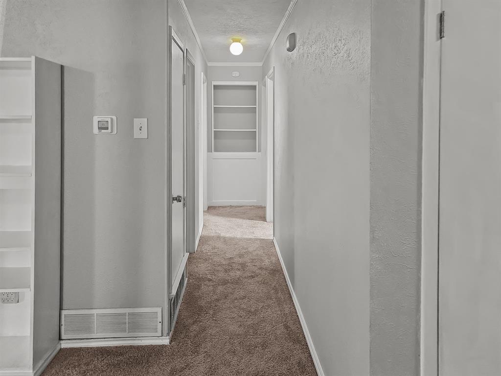 701 Idlewilde Drive Lewisville, TX 75067 - Photo 6 of 13 Hallway featuring updated carpet