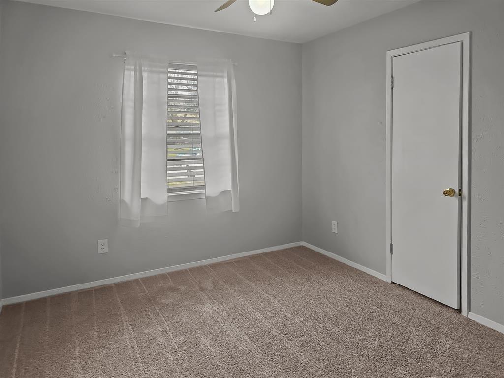 701 Idlewilde Drive Lewisville, TX 75067 - Photo 8 of 13 Guest bedroom with new carpet & ceiling fan