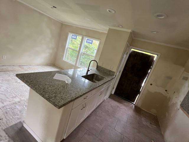14-823 Seaview Road Pahoa, HI 96778 - Photo 6 of 17 a kitchen with granite countertop a sink and a stove top oven with granite countertops