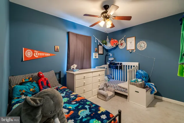 a bedroom with furniture and a baby crib
