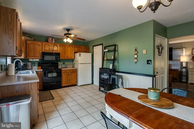 a kitchen with stainless steel appliances wooden floor dining table and chairs