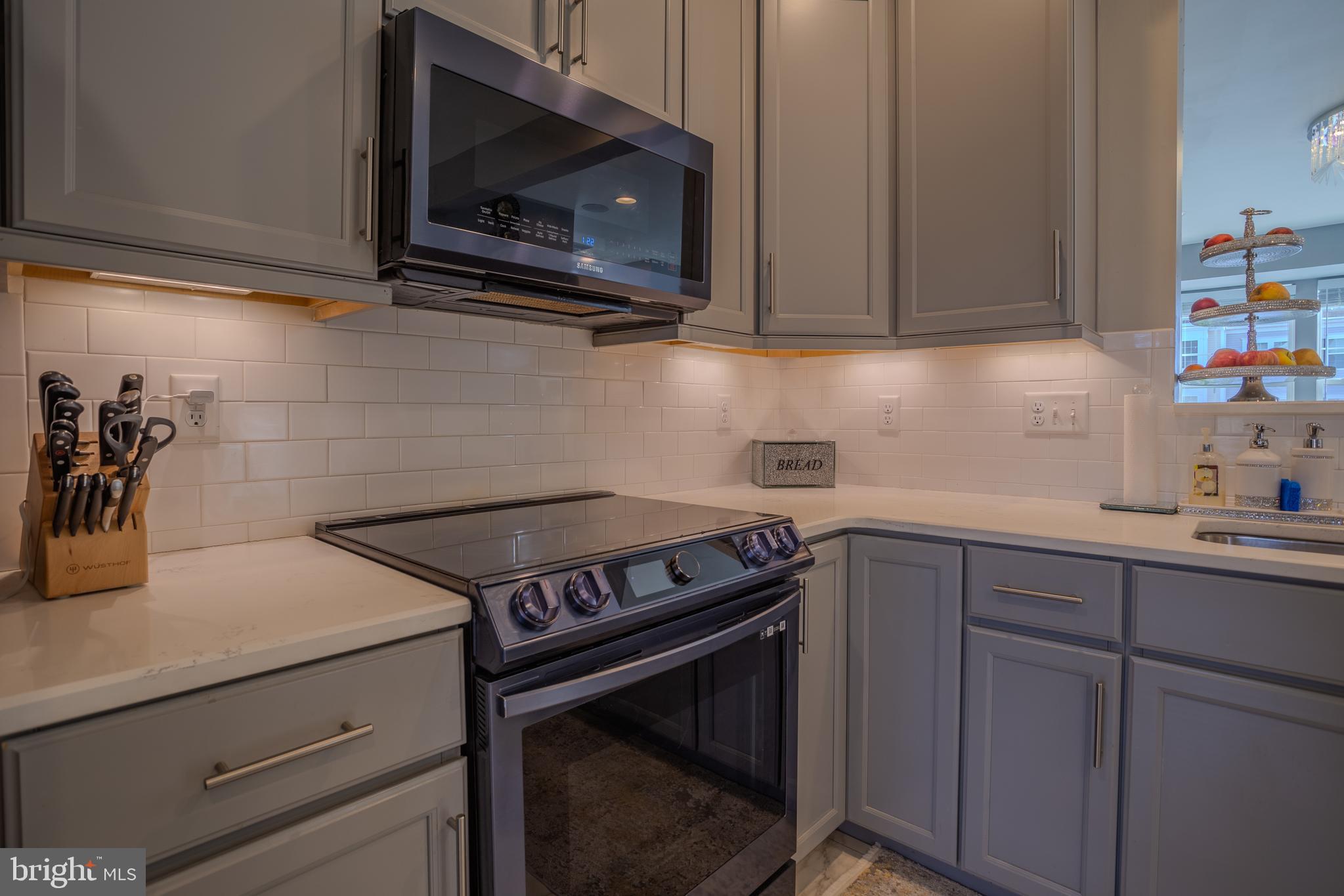 35 Landis Court Falling Waters, WV 25419 - Photo 10 of 64 a kitchen with wooden cabinets stainless steel appliances and a sink
