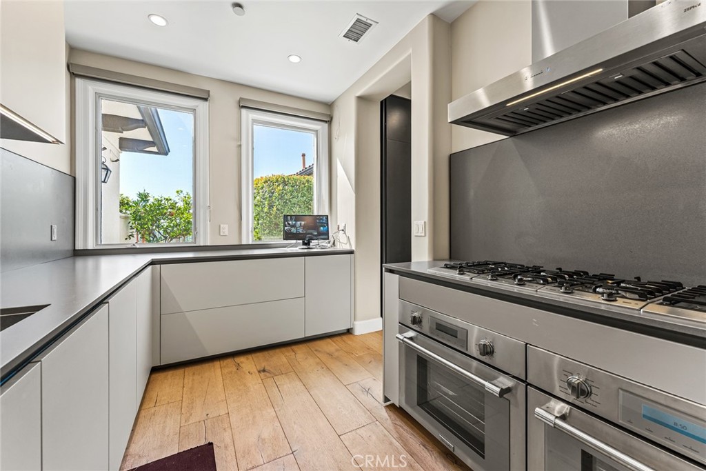 11765 Riehl Avenue Tustin, CA 92782 - Photo 26 of 53 a kitchen with a stove and a refrigerator