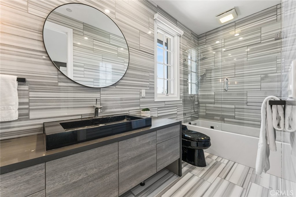 11765 Riehl Avenue Tustin, CA 92782 - Photo 46 of 53 a bathroom with a sink a mirror and a shower