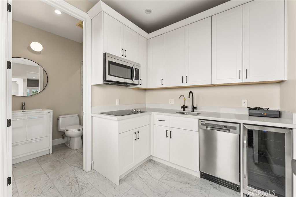 11765 Riehl Avenue Tustin, CA 92782 - Photo 49 of 53 a kitchen with cabinets appliances and a sink