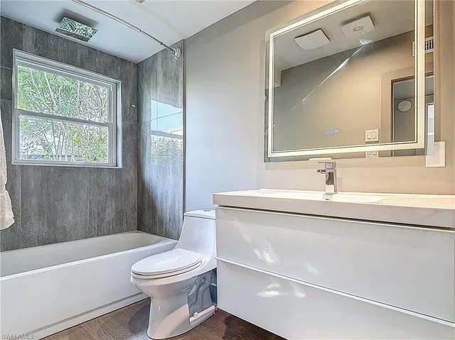 a bathroom with a sink a toilet and a bathtub