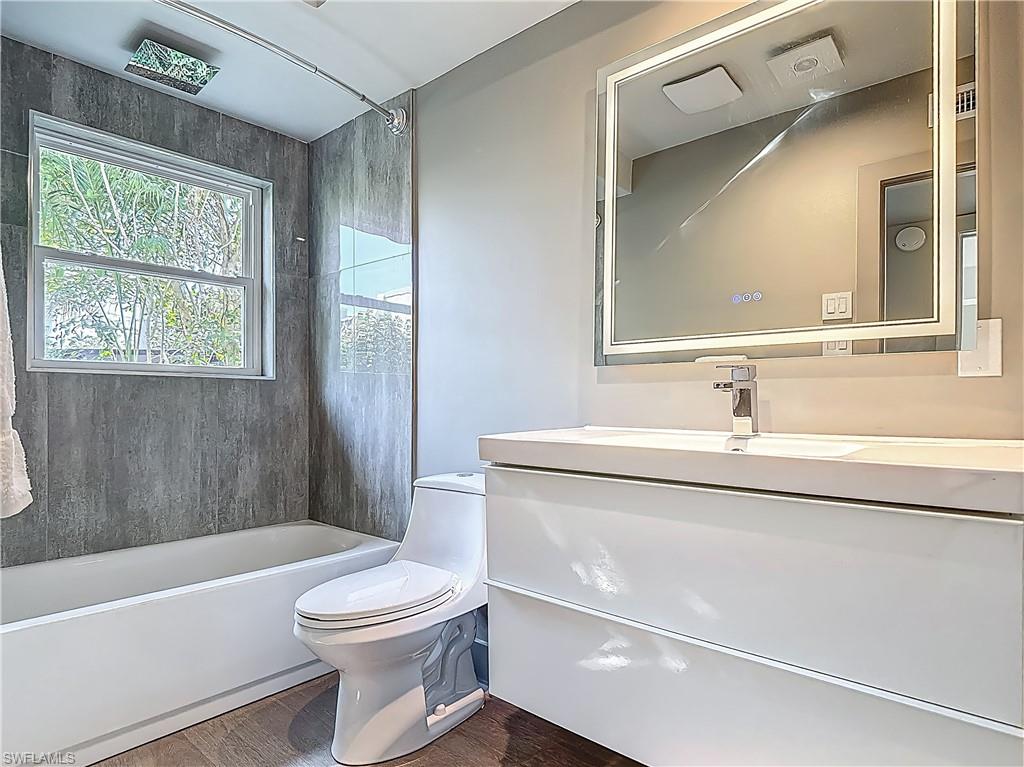 2544 First Street, Unit 102 Fort Myers, FL 33901 - Photo 11 of 19 a bathroom with a sink a toilet and a bathtub