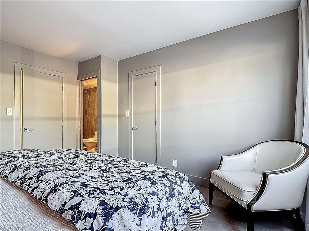 2544 First Street, Unit 102 Fort Myers, FL 33901 - Photo 13 of 19 a bedroom with a bed and a chair