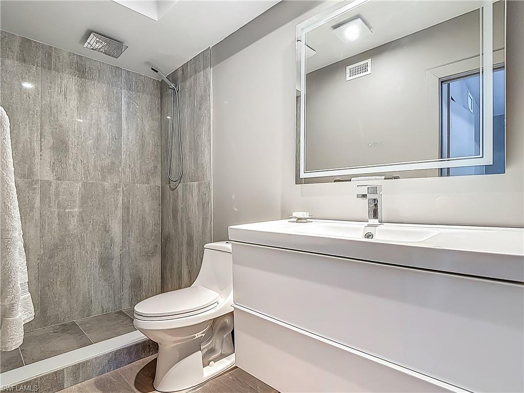 2544 First Street, Unit 102 Fort Myers, FL 33901 - Photo 14 of 19 a bathroom with a sink a toilet a mirror and shower