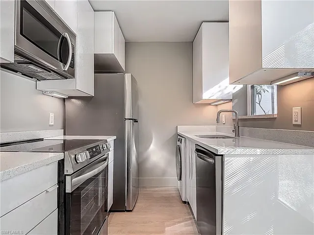 a kitchen with a stove microwave and sink