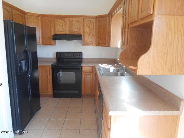 114 Circulo Penjamo Rio Rico, AZ 85648 - Photo 7 of 16 a kitchen with a refrigerator and a sink