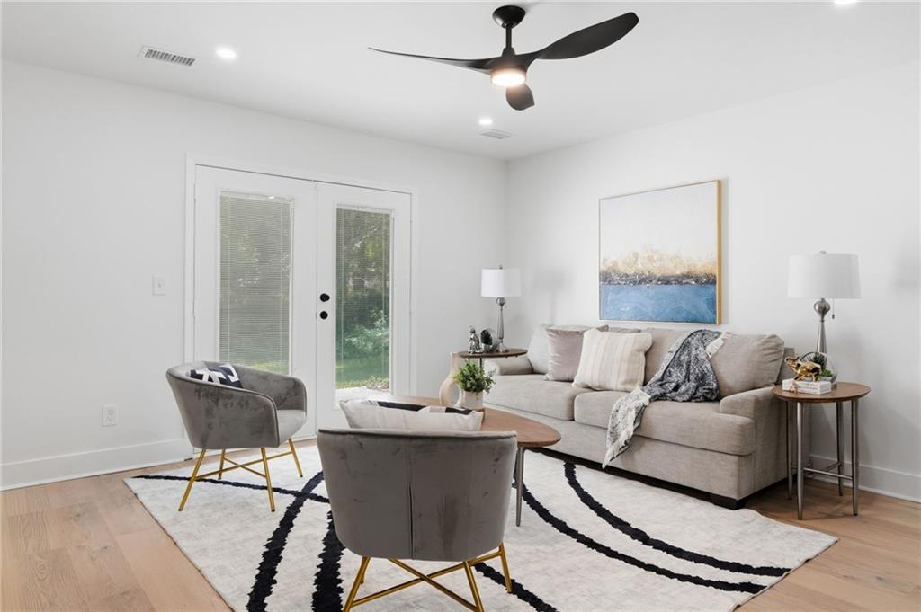 1808 Singer Way Lithonia, GA 30058 - Photo 16 of 37 a living room with furniture and a chandelier