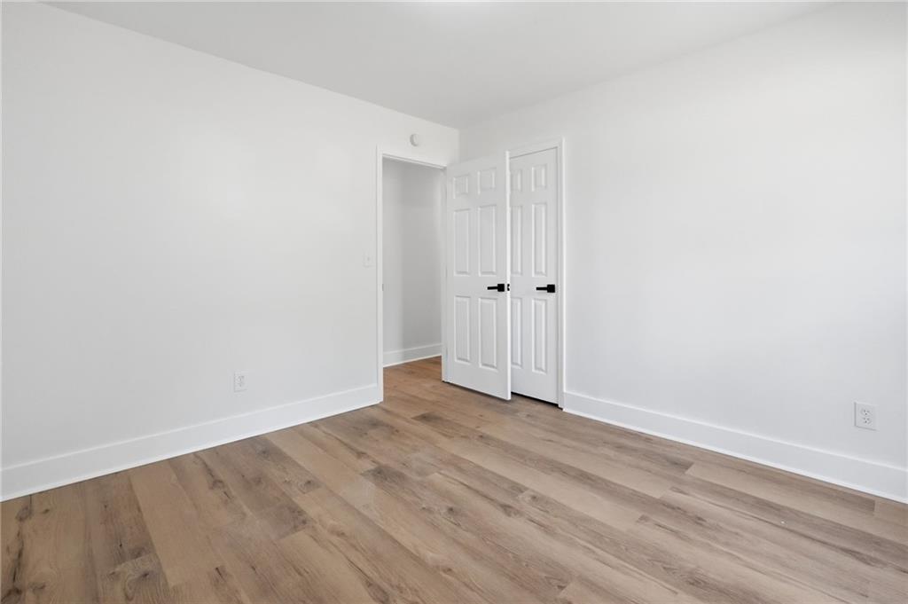 1808 Singer Way Lithonia, GA 30058 - Photo 20 of 37 a view of an empty room with wooden floor