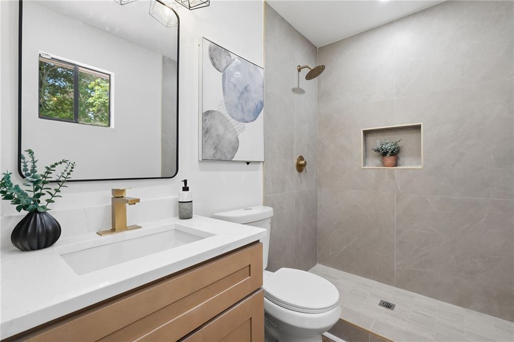 1808 Singer Way Lithonia, GA 30058 - Photo 23 of 37 a bathroom with a sink a toilet and shower