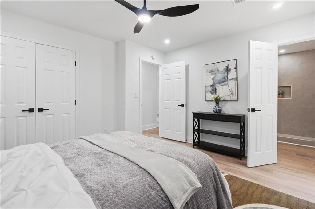1808 Singer Way Lithonia, GA 30058 - Photo 26 of 37 a bedroom with a bed and a chandelier