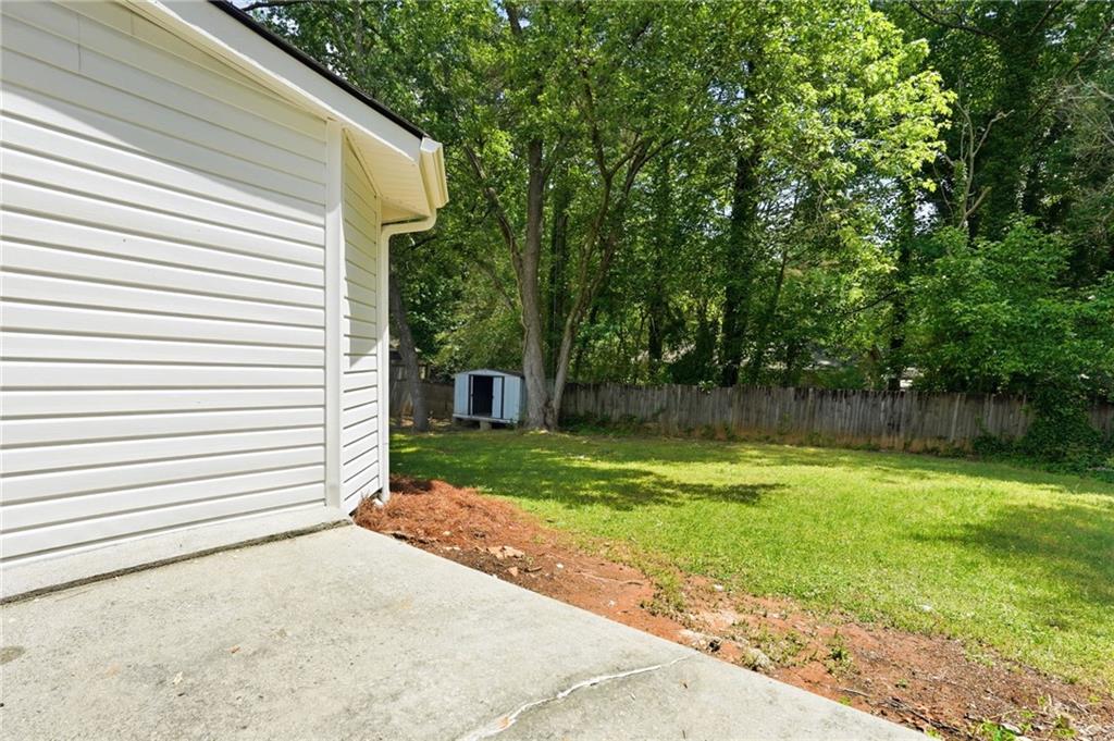 1808 Singer Way Lithonia, GA 30058 - Photo 27 of 37 a view of a backyard with large trees