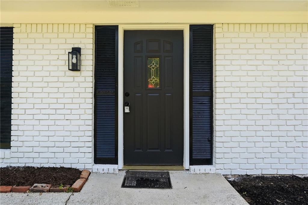 1808 Singer Way Lithonia, GA 30058 - Photo 3 of 37 a front view of a house with a brick wall