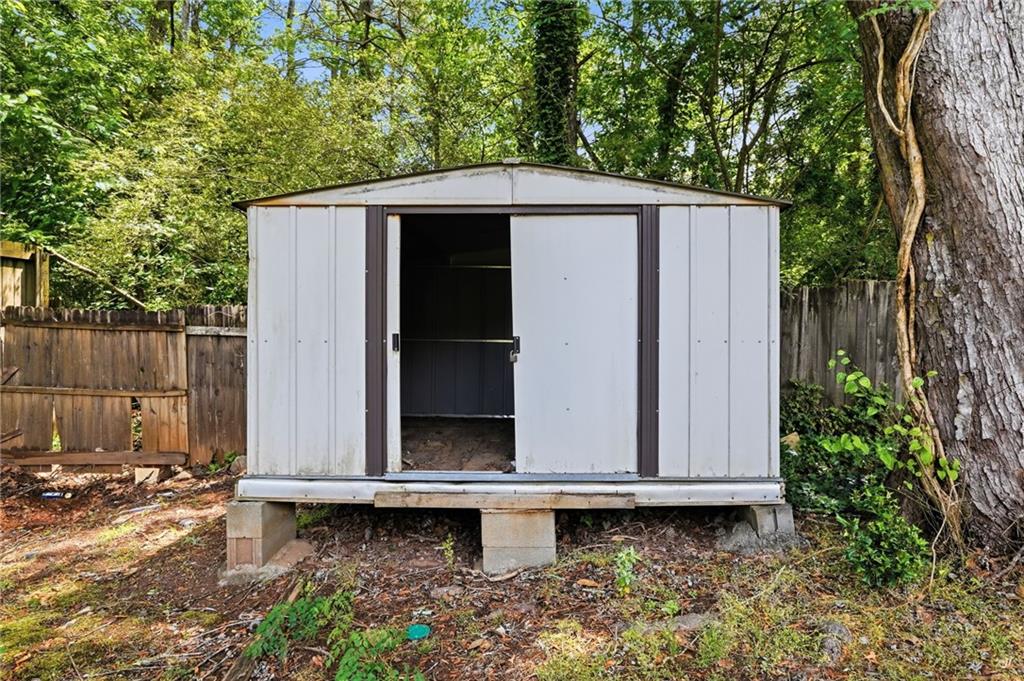 1808 Singer Way Lithonia, GA 30058 - Photo 35 of 37 a backyard of a house with a bench and trees
