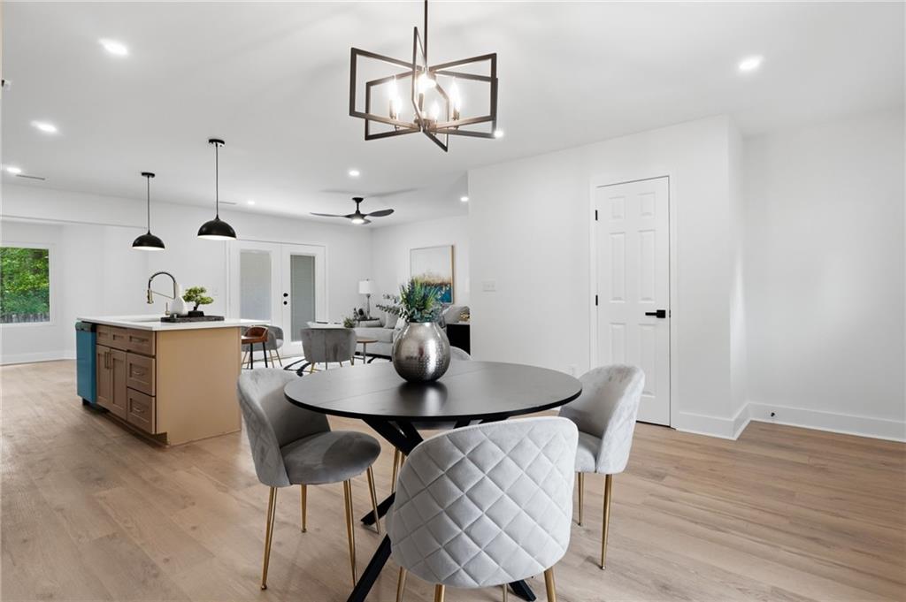 1808 Singer Way Lithonia, GA 30058 - Photo 6 of 37 a view of a dining room with furniture and wooden floor