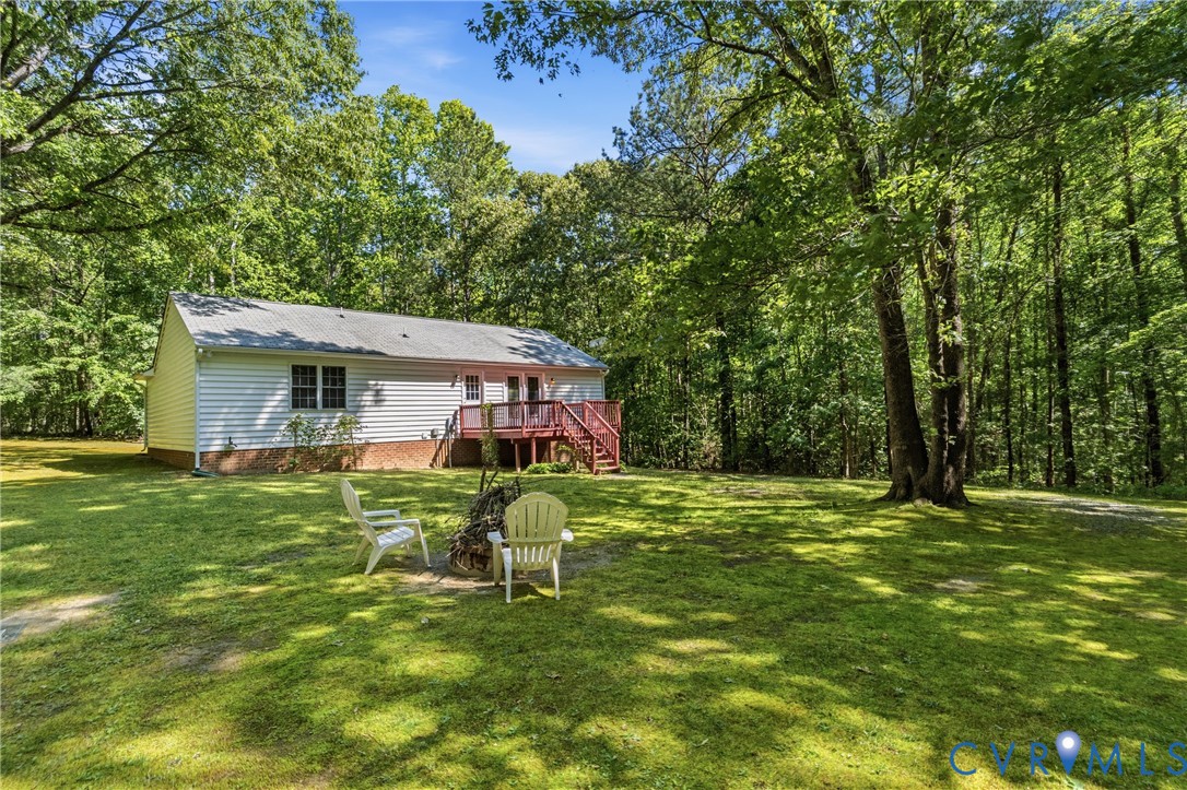 12654 Mt Olive Cohoke Road West Point, VA 23181 - Photo 30 of 31 a backyard of a house with table and chairs