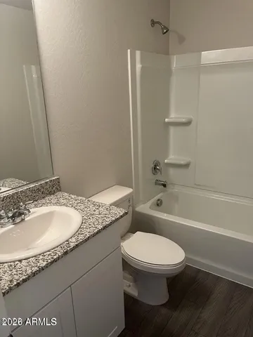 a large kitchen with cabinets wooden floor and stainless steel appliances