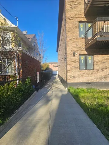 a view of a brick house with a yard