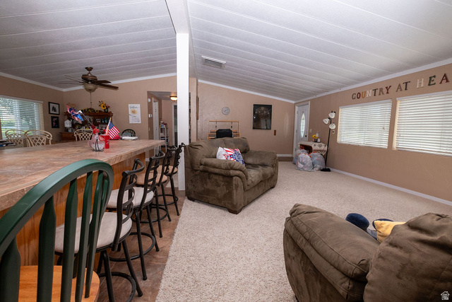 855 East 300 N Street Beaver, UT 84713 - Photo 17 of 44 Open-concept living space featuring vaulted ceilings, light-tone carpeting, and multiple windows with horizontal blinds
