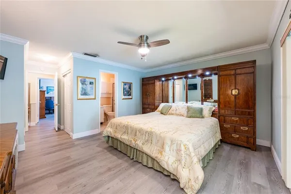 a bedroom with a bed and wooden floor