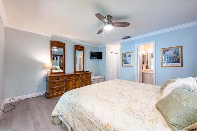 a bedroom with a bed and a dresser with rug