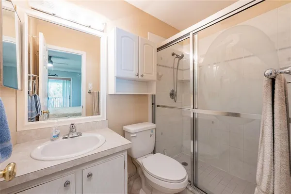 a bedroom with a bed a desk and chair with a bookshelf