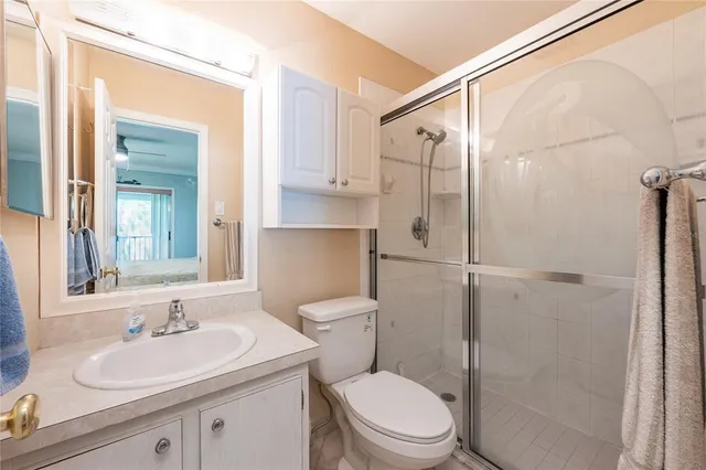 a bedroom with a bed a desk and chair with a bookshelf