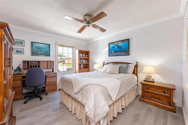 a bedroom with a bed and a wooden floor