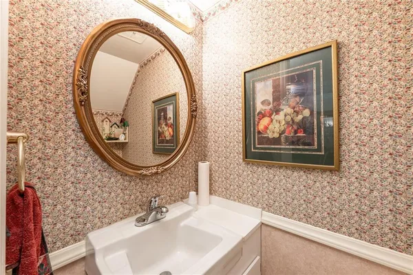 a white toilet sitting next to a bathroom sink
