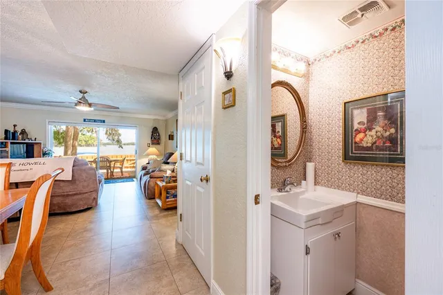 view of a hallway with stairs and a closet