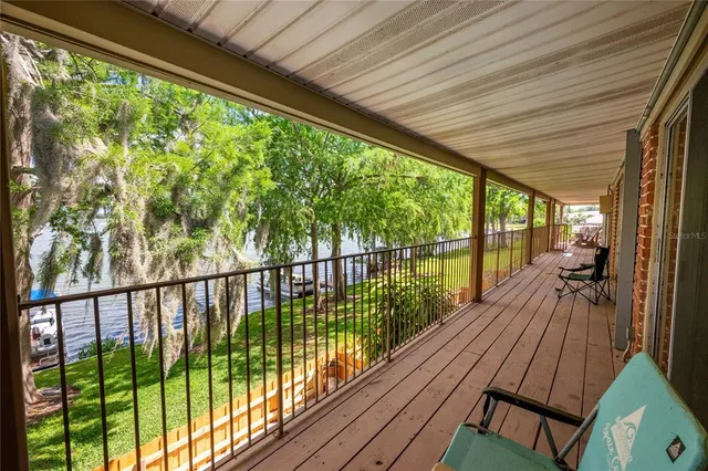 a view of a wooden deck and lake