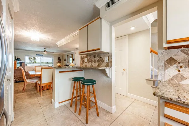 a kitchen with stainless steel appliances granite countertop a refrigerator a stove and a sink